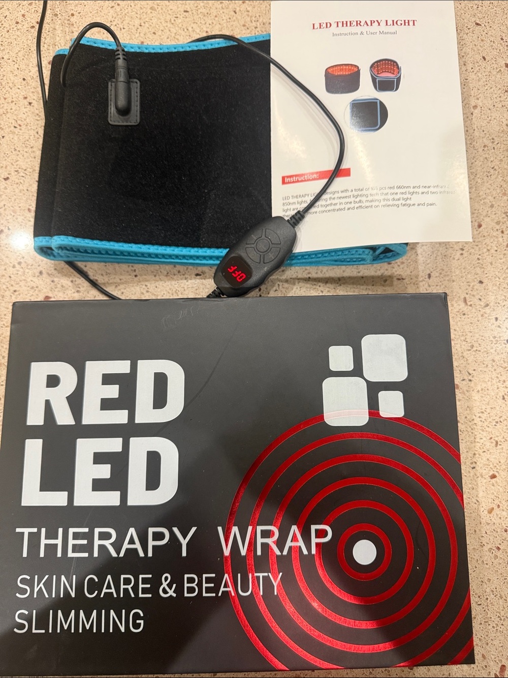 New in box.  Red LED Therapy Wrap with Blue Trim